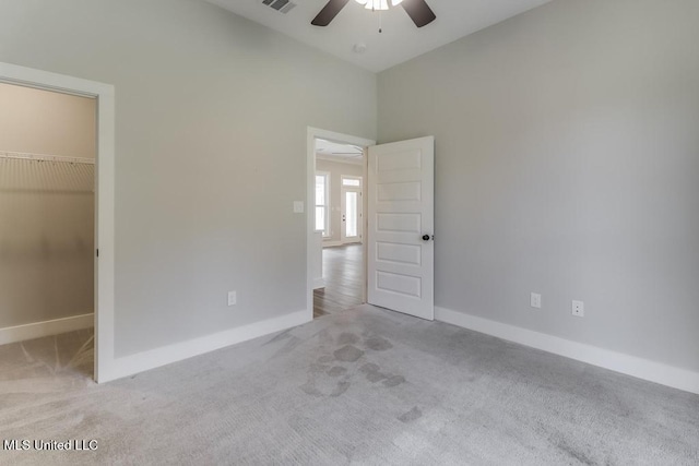 16043 W Dedeaux Rd, Gulfport, MS 39503 - unfurnished bedroom featuring a spacious closet, carpet floors, a ceiling fan, a closet, and a high ceiling