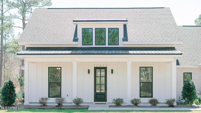 16043 W Dedeaux Rd, Gulfport, MS 39503 - view of front facade featuring board and batten siding, a metal roof, and a porch