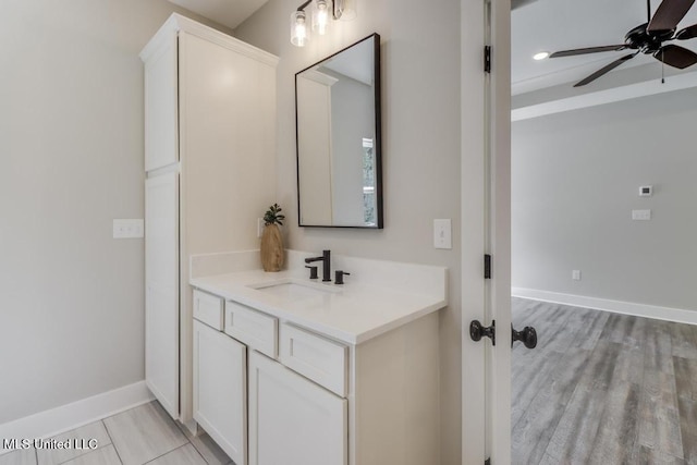 16043 W Dedeaux Rd, Gulfport, MS 39503 - bathroom featuring vanity, a ceiling fan, and wood finished floors