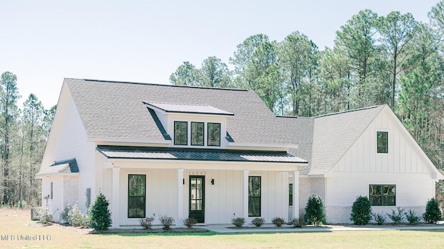 16043 W Dedeaux Rd, Gulfport, MS 39503 - modern farmhouse featuring board and batten siding, a metal roof, covered porch, and a front lawn