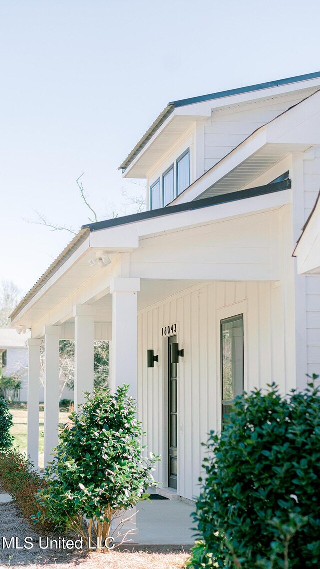 16043 W Dedeaux Rd, Gulfport, MS 39503 - doorway to property with board and batten siding and covered porch