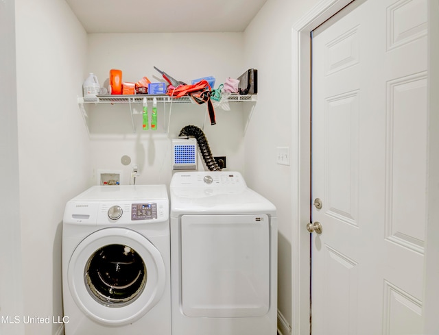 clothes washing area with washing machine and dryer