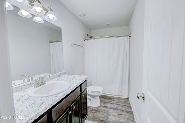 bathroom with vanity, hardwood / wood-style floors, and toilet