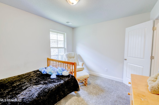 bedroom with a textured ceiling and carpet flooring