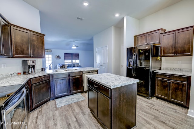 kitchen featuring ceiling fan, appliances with stainless steel finishes, light hardwood / wood-style flooring, and kitchen peninsula