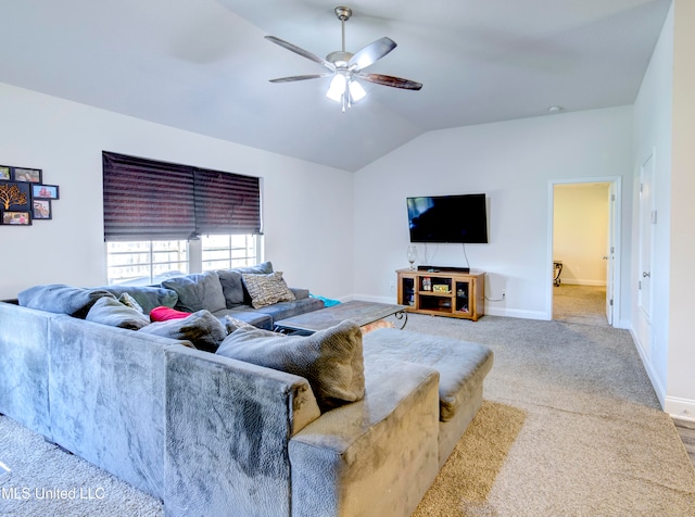 carpeted living room with ceiling fan and vaulted ceiling