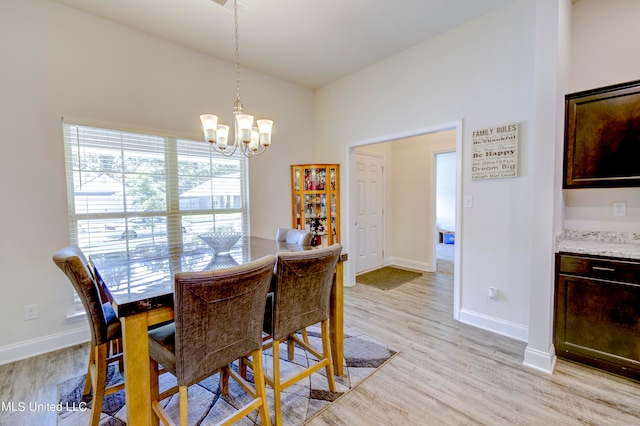 dining room with an inviting chandelier and light wood-type flooring