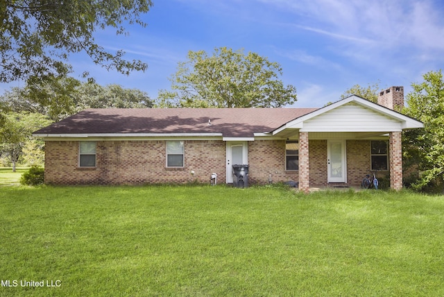 7520 Ogborn Dr, Moss Point, MS 39562 - ranch-style home with a front lawn, brick siding, and a chimney