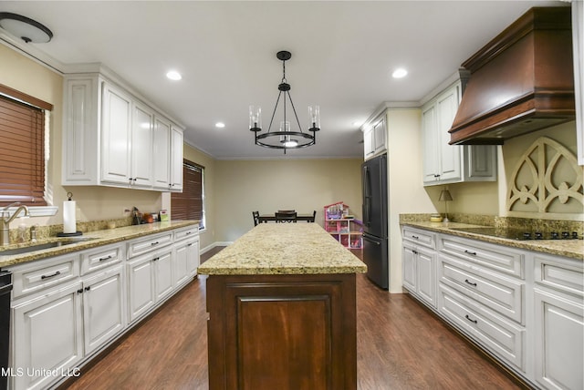 7520 Ogborn Dr, Moss Point, MS 39562 - kitchen featuring black appliances, premium range hood, a sink, a chandelier, and a kitchen island