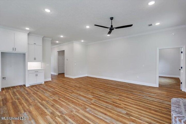 unfurnished living room with ornamental molding, light hardwood / wood-style flooring, a textured ceiling, and ceiling fan