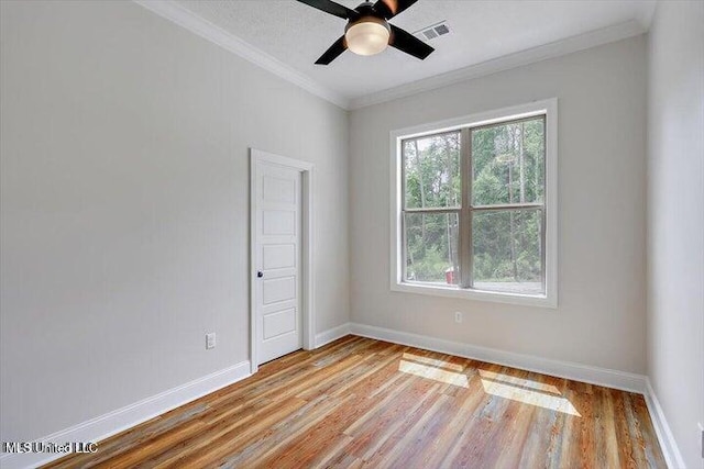 empty room with ornamental molding, light hardwood / wood-style flooring, and ceiling fan