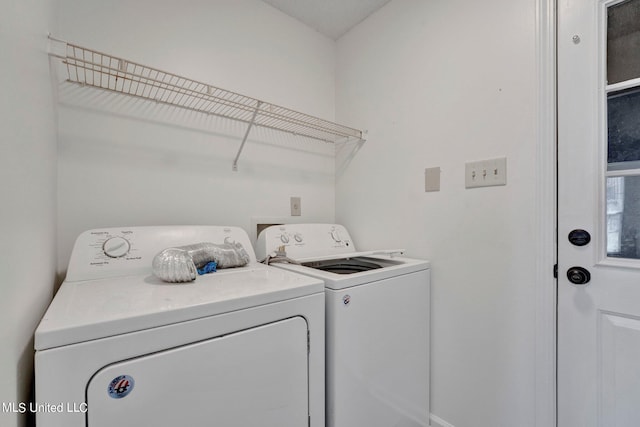 clothes washing area with washing machine and clothes dryer