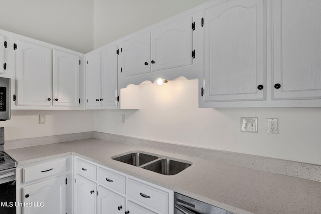 kitchen with white cabinetry, appliances with stainless steel finishes, and sink