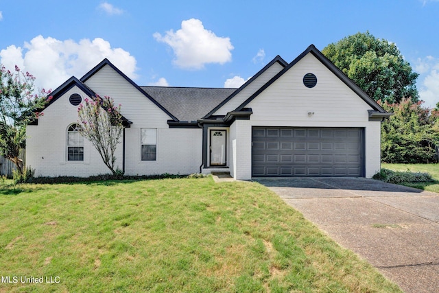 view of front of property with a front yard and a garage