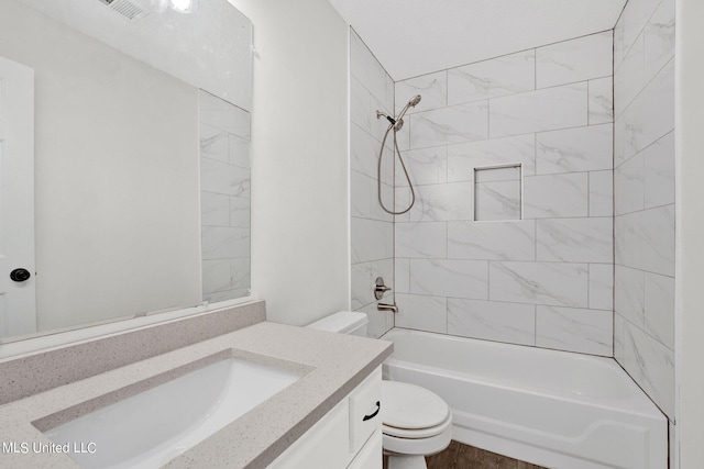 full bathroom featuring toilet, tiled shower / bath combo, and vanity