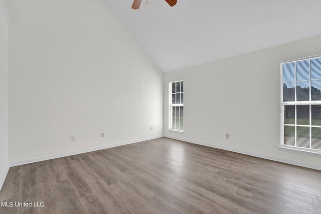 empty room with a wealth of natural light, high vaulted ceiling, light hardwood / wood-style floors, and ceiling fan