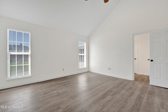 unfurnished room featuring hardwood / wood-style floors, high vaulted ceiling, and ceiling fan