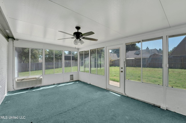 unfurnished sunroom featuring ceiling fan and a wealth of natural light