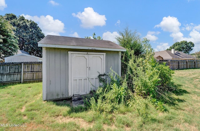 view of outbuilding with a lawn