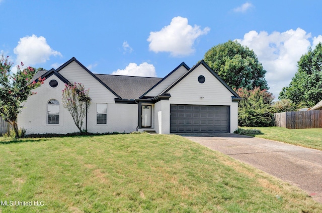 view of front of home with a front lawn and a garage