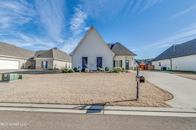 french provincial home featuring a garage