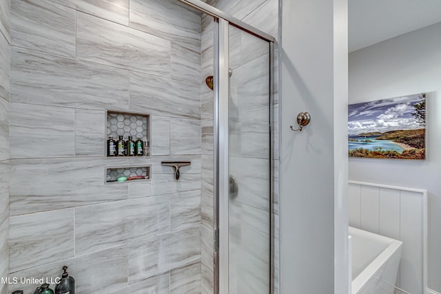 bathroom featuring a shower with door