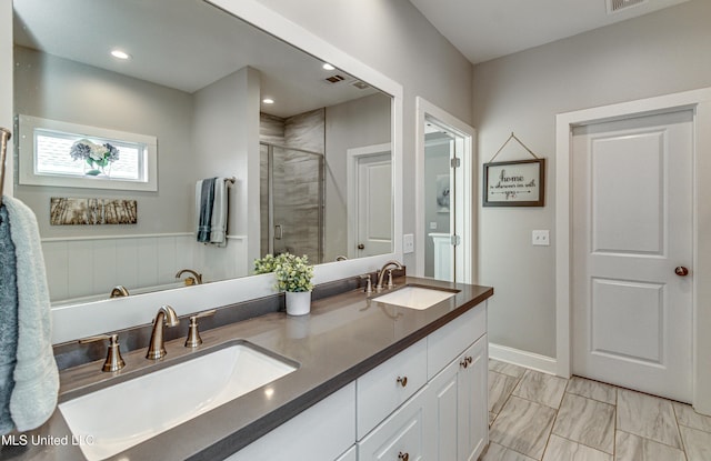 bathroom with walk in shower and vanity