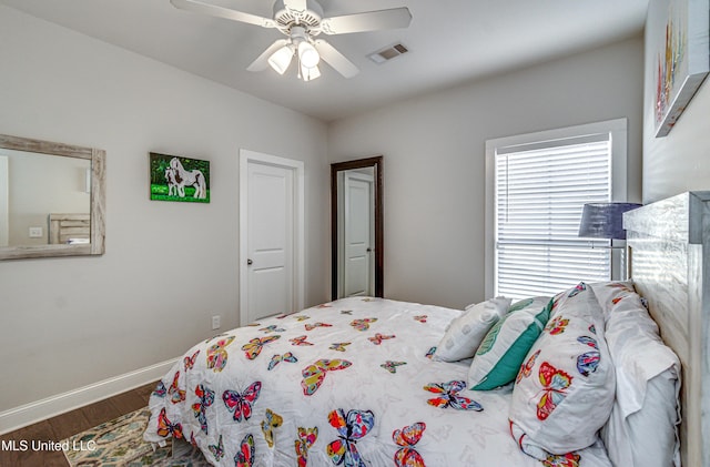 bedroom featuring dark wood-type flooring and ceiling fan