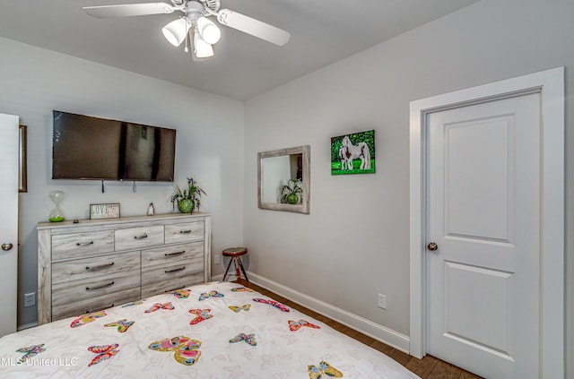 bedroom with ceiling fan and dark hardwood / wood-style flooring