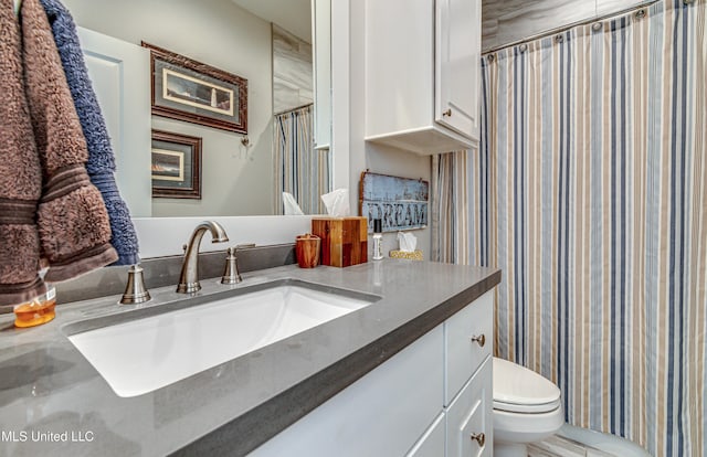 bathroom with vanity, toilet, and curtained shower