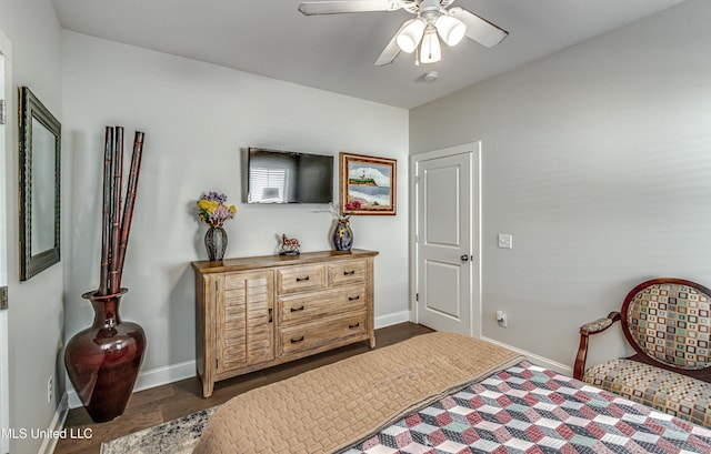 bedroom with dark hardwood / wood-style floors and ceiling fan