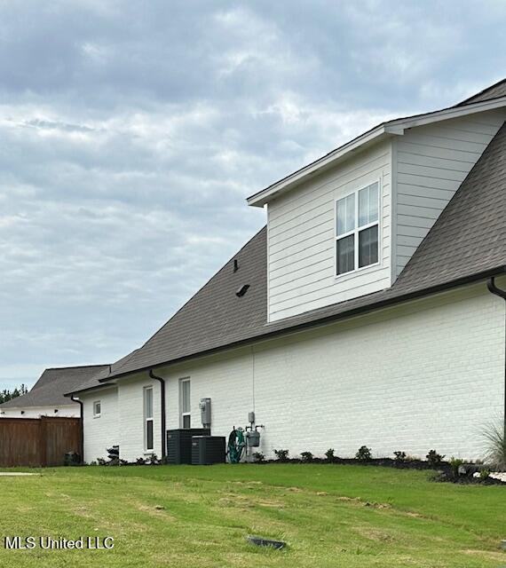 exterior space with a yard and central AC unit