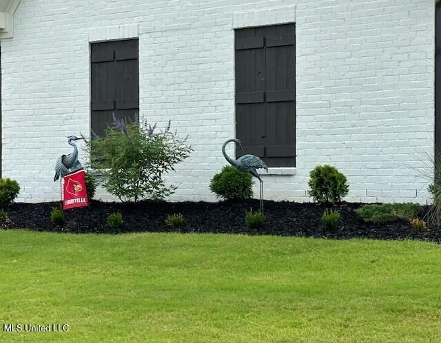 view of side of property with a lawn