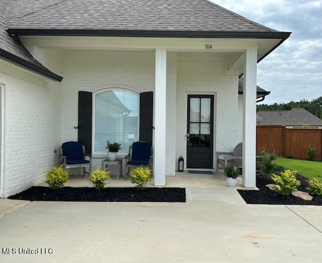 view of exterior entry with covered porch