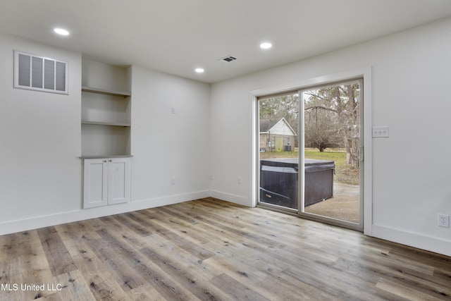 unfurnished room featuring light wood-type flooring