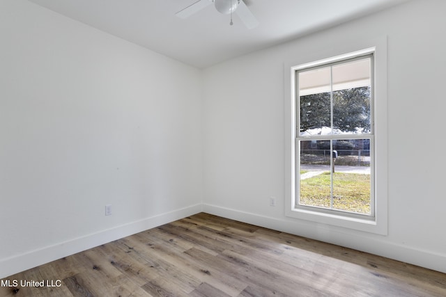 empty room with ceiling fan, light hardwood / wood-style flooring, and a wealth of natural light