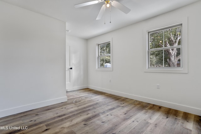 empty room featuring ceiling fan and light hardwood / wood-style flooring