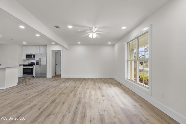 unfurnished living room with ceiling fan and light hardwood / wood-style floors