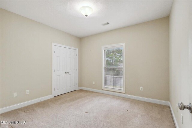 403 Chesney Ct, Madison, MS 39110 - unfurnished bedroom featuring light carpet, baseboards, and a closet