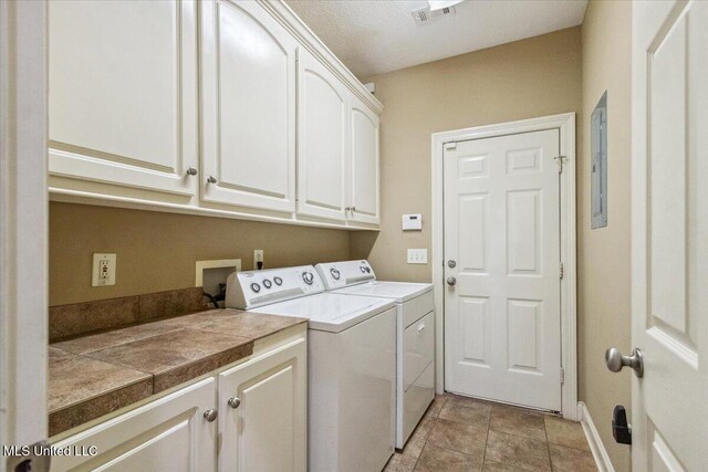 403 Chesney Ct, Madison, MS 39110 - clothes washing area featuring cabinet space, independent washer and dryer, baseboards, and light tile patterned floors