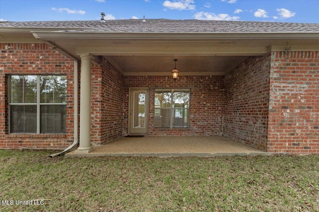 403 Chesney Ct, Madison, MS 39110 - doorway to property with brick siding, a yard, and a patio area