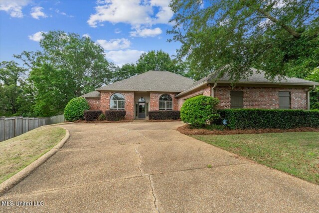 403 Chesney Ct, Madison, MS 39110 - view of front facade with concrete driveway, brick siding, an attached garage, and a shingled roof