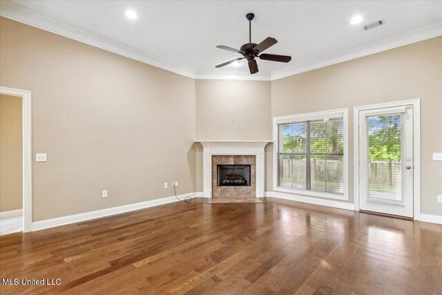 403 Chesney Ct, Madison, MS 39110 - unfurnished living room with ceiling fan, a tile fireplace, wood finished floors, crown molding, and baseboards