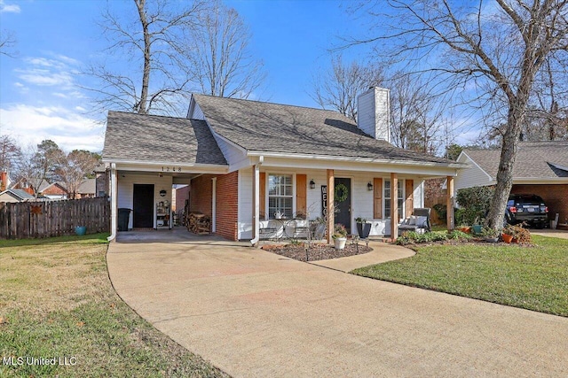 view of front facade with a porch, a front yard, and a carport