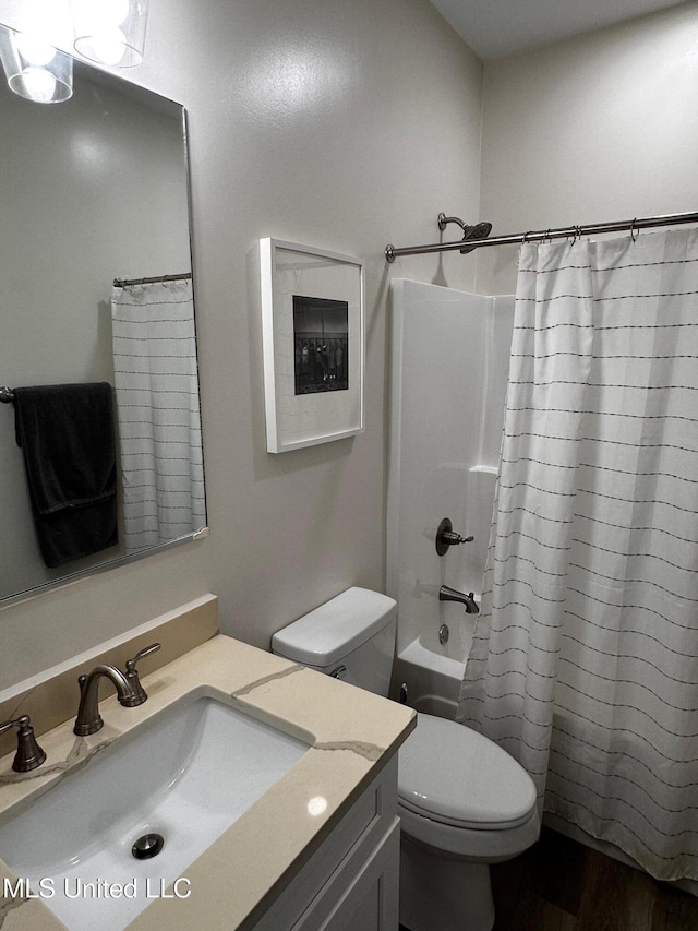 bathroom featuring toilet, vanity, and shower / bath combo with shower curtain