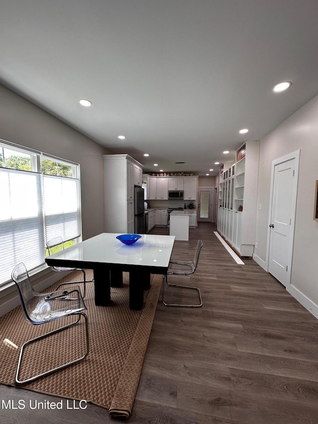 dining space with dark wood-style flooring, baseboards, and recessed lighting