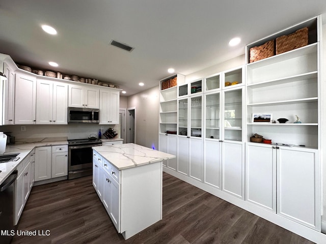 kitchen featuring dark wood finished floors, white cabinetry, open shelves, visible vents, and stainless steel appliances