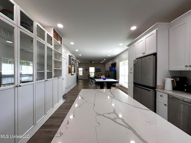 kitchen featuring white cabinets, recessed lighting, dark wood-style flooring, stainless steel appliances, and open floor plan