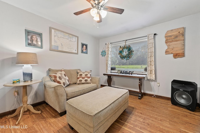 sitting room with ceiling fan and light wood-type flooring