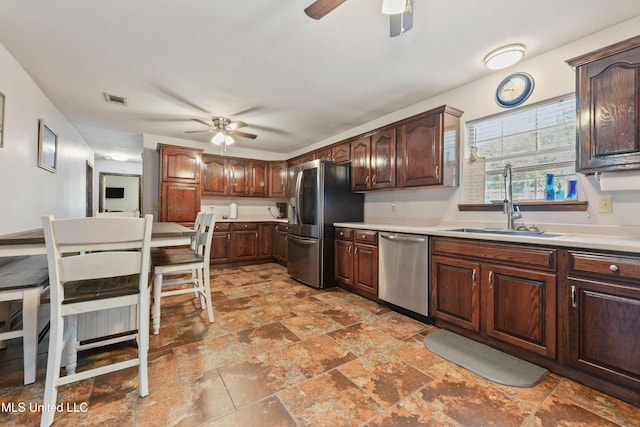 kitchen featuring ceiling fan, sink, and stainless steel appliances